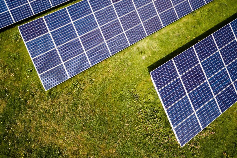 RV with rooftop solar panels in scenic wilderness